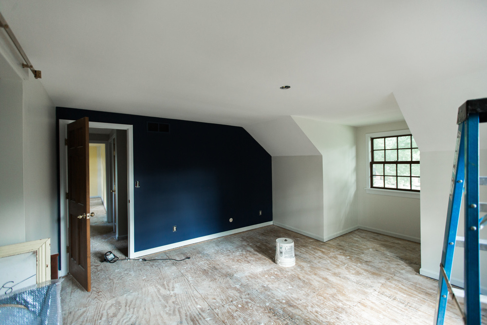 Another big change was the master bedroom with light walls and a navy accent wall.