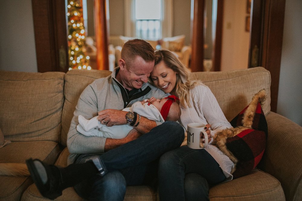 Mom and dad snuggle their newly adopted baby just in time for Christmas
