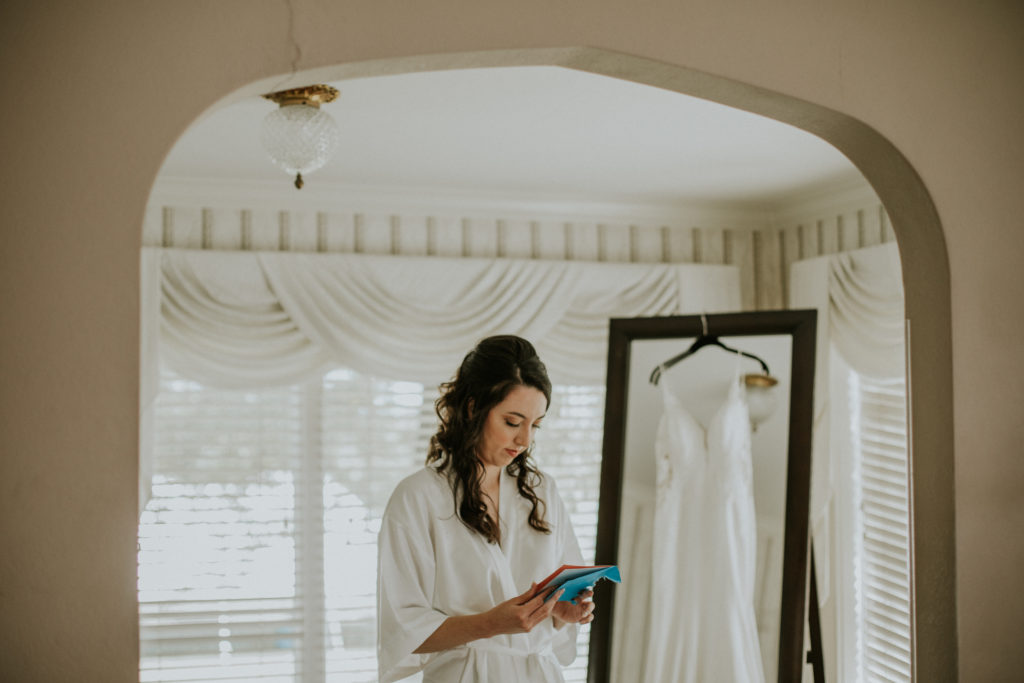 Bride alone quietly reading a letter from her groom